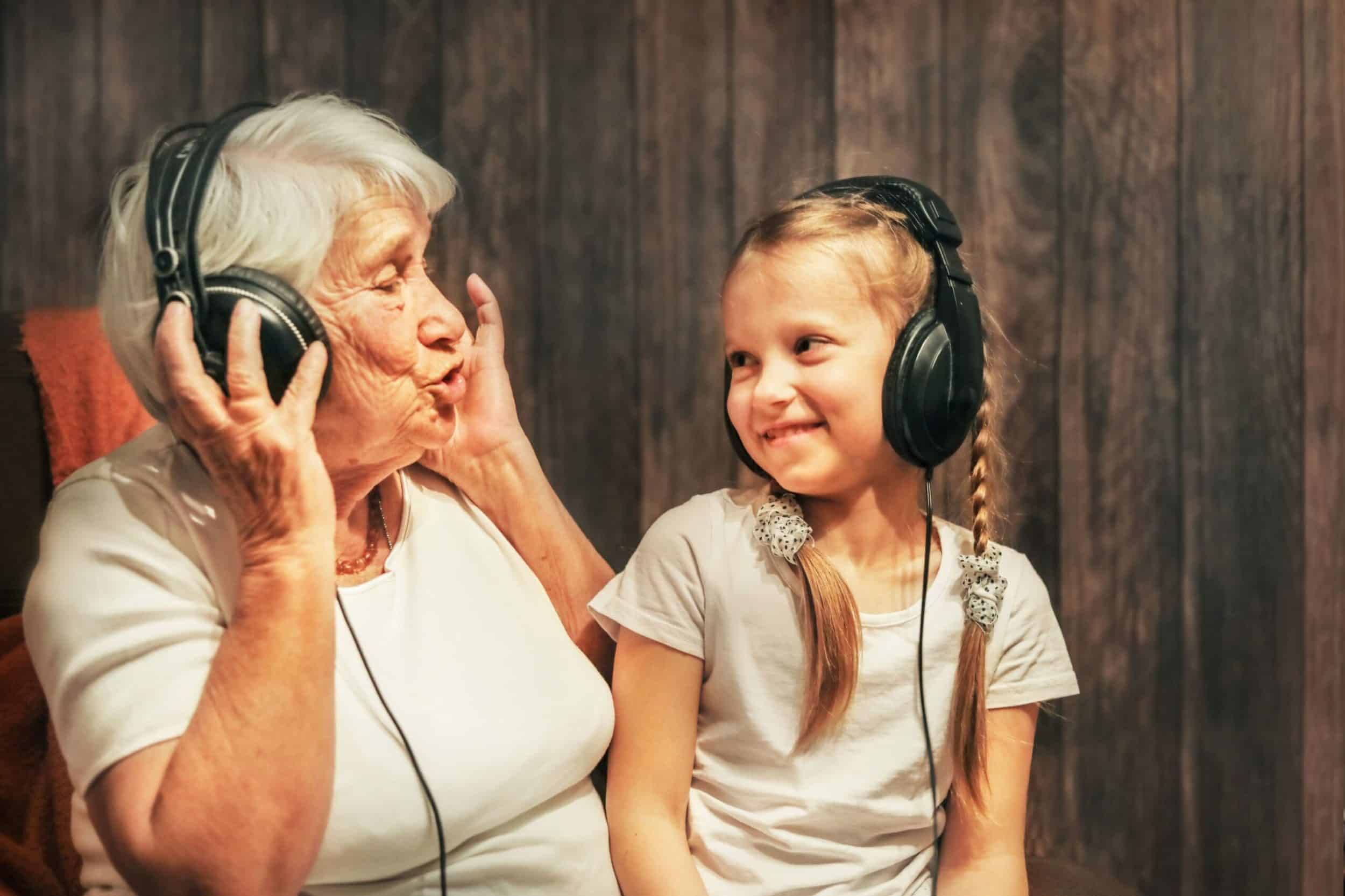 Old person and child listening to music