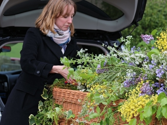 Woman adding flowers onto a coffin