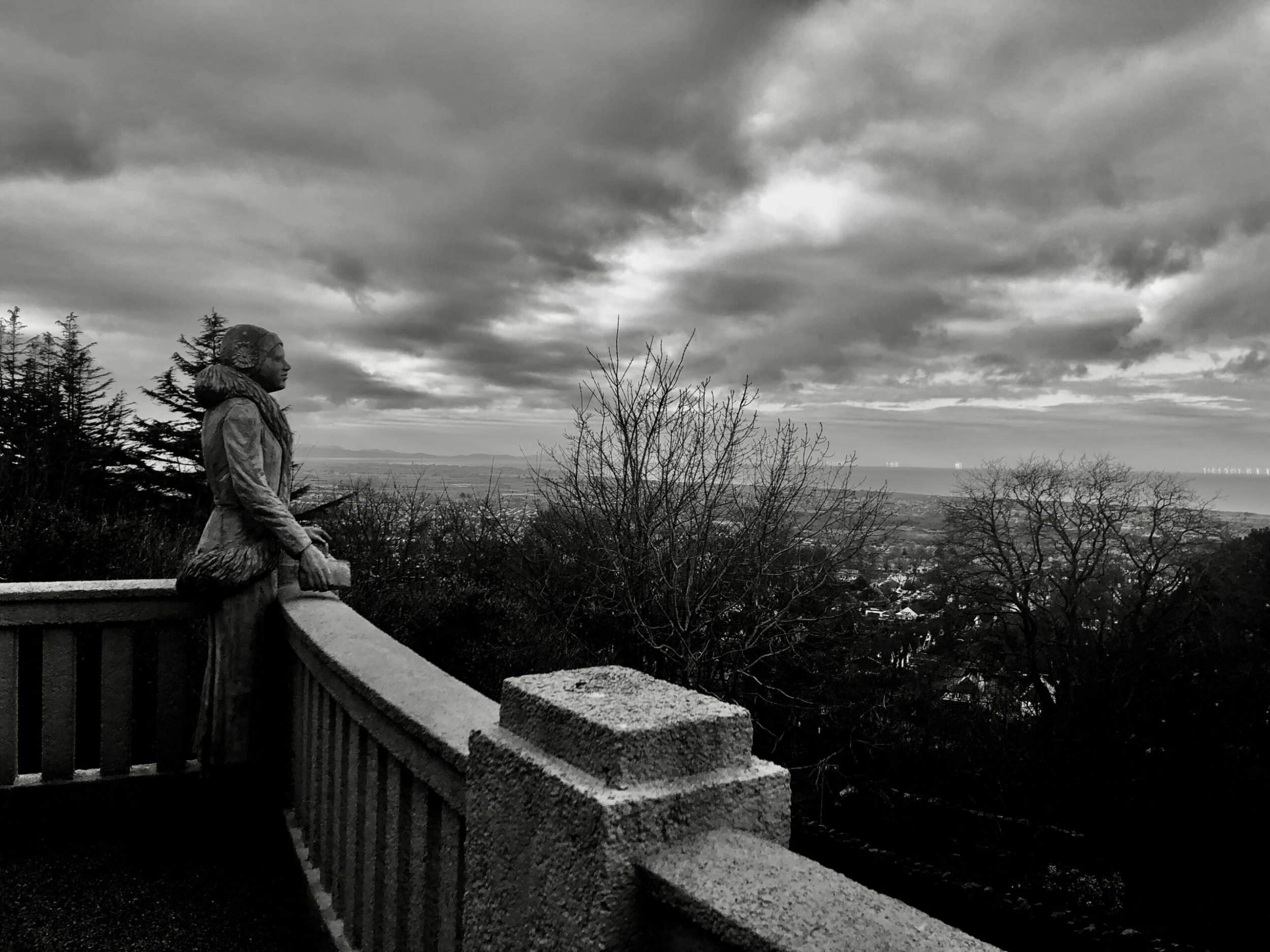 Image of person looking out of balcony